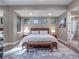 Relaxing primary bedroom with large windows and a wood platform bed at 1970 Laurel Rd, Winter Park, FL 32789