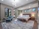 Main bedroom features natural light, accent chair, and neutral tones for a serene atmosphere at 1970 Laurel Rd, Winter Park, FL 32789