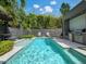 Inviting pool area features sparkling water, lounge chairs, and an outdoor kitchen with a built-in grill, perfect for entertaining at 1970 Laurel Rd, Winter Park, FL 32789