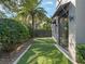 Green side yard with artificial turf, providing a low-maintenance outdoor space, alongside a modern home at 1970 Laurel Rd, Winter Park, FL 32789
