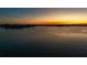 Aerial view of tranquil lake at sunset, showcasing the expansive water and serene environment at 2020 Venetian Way, Winter Park, FL 32789