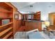 Home wet bar with wood paneling, shelving, and ample counter space for entertaining at 2020 Venetian Way, Winter Park, FL 32789