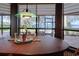 Bright dining room with lake views, a decorative orchid, and lovely green glass pendant lighting fixture at 2020 Venetian Way, Winter Park, FL 32789