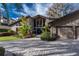 Stunning home exterior with stone accents, well-manicured landscaping, and a paved driveway at 2020 Venetian Way, Winter Park, FL 32789