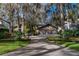 Spacious home with a three-car garage, stone details, and meticulously maintained landscaping at 2020 Venetian Way, Winter Park, FL 32789