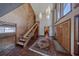 Elegant foyer featuring soaring ceilings, unique lighting, a staircase, and tile flooring with an oriental rug at 2020 Venetian Way, Winter Park, FL 32789
