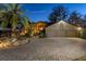 Beautiful home exterior with mature palms, stone accents, lush landscaping, and a spacious paver driveway at 2020 Venetian Way, Winter Park, FL 32789