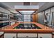 Modern kitchen features a large central island with built-in cooktop and stainless steel appliances at 2020 Venetian Way, Winter Park, FL 32789
