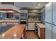 Kitchen features updated cabinets, stainless steel appliances, and a dedicated desk area at 2020 Venetian Way, Winter Park, FL 32789