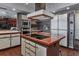 Kitchen island with cooktop and stainless-steel microwave and oven appliance suite at 2020 Venetian Way, Winter Park, FL 32789