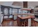 Large kitchen area includes stainless steel appliances, an island cooktop and an adjacent living area at 2020 Venetian Way, Winter Park, FL 32789