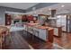 Kitchen with stainless-steel appliances, a cooktop island and an open-concept floor plan at 2020 Venetian Way, Winter Park, FL 32789