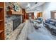 Open-concept living room boasts a stone fireplace and convenient bar area at 2020 Venetian Way, Winter Park, FL 32789