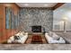 Cozy living room featuring a stone fireplace, unique architectural details, and comfortable seating at 2020 Venetian Way, Winter Park, FL 32789
