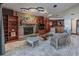 Beautiful living room features a stone fireplace, stylish lighting, and built-in bookshelves at 2020 Venetian Way, Winter Park, FL 32789