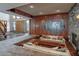 Spacious living room features a sunken seating area, statement fireplace, and elegant wood paneling at 2020 Venetian Way, Winter Park, FL 32789