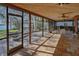 Large tiled patio and screened porch overlooking the backyard and lake with gazebo at 2020 Venetian Way, Winter Park, FL 32789