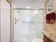 This bathroom offers a glass-enclosed shower, granite countertops, and grab bars for accessibility at 2055 S Atlantic Ave # 1604, Daytona Beach, FL 32118