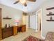 A spare bedroom area with tile floors, a ceiling fan, a work desk, and built-in shelving at 2055 S Atlantic Ave # 1604, Daytona Beach, FL 32118