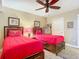 A charming bedroom with two beds, ceiling fan, and tasteful decor at 2055 S Atlantic Ave # 1604, Daytona Beach, FL 32118