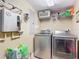 Functional laundry room equipped with a washer, dryer, and ample storage shelving at 2055 S Atlantic Ave # 1604, Daytona Beach, FL 32118