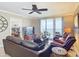 Comfortable living room with leather furniture, ceiling fan, and scenic ocean views at 2055 S Atlantic Ave # 1604, Daytona Beach, FL 32118