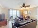 A cozy living room featuring a sofa, armchairs, ceiling fan, and oceanfront views at 2055 S Atlantic Ave # 1604, Daytona Beach, FL 32118