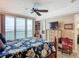 Comfortable main bedroom features a decorative dresser, ceiling fan, and an outdoor balcony for added convenience at 2055 S Atlantic Ave # 1604, Daytona Beach, FL 32118
