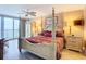 Elegant main bedroom boasts a four-poster bed and a balcony that overlooks the ocean at 2055 S Atlantic Ave # 1604, Daytona Beach, FL 32118