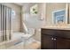 Bathroom showcasing a shower-tub combo, vanity, and tiled accents for a clean aesthetic at 2109 E Central Blvd, Orlando, FL 32803