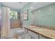 Bathroom featuring a tiled shower, granite countertop, and a window offering natural light at 2109 E Central Blvd, Orlando, FL 32803