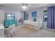 Bright bedroom with lilac walls, study space and relaxing hammock swing at 2109 E Central Blvd, Orlando, FL 32803