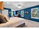 Large bedroom with carpet, blue walls, bright windows, a bed, and a lounge area at 2109 E Central Blvd, Orlando, FL 32803