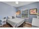 Bright bedroom with natural light, wood floors, complemented by tasteful décor and furnishings at 2109 E Central Blvd, Orlando, FL 32803
