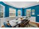 Bright dining room featuring a dark wood table, wainscoting, and a colorful rug at 2109 E Central Blvd, Orlando, FL 32803