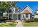Beautiful two story home with a well maintained lawn, lovely landscaping, inviting front porch and a brick walkway at 2109 E Central Blvd, Orlando, FL 32803