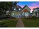 Charming two-story home with a covered porch, manicured landscaping, and unique architectural details at 2109 E Central Blvd, Orlando, FL 32803