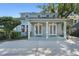 Charming home with a welcoming front porch featuring white columns and double glass front doors at 2109 E Central Blvd, Orlando, FL 32803