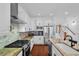 Modern kitchen with granite countertops, stainless steel appliances, white cabinetry, hardwood floors, and tile backsplash at 2109 E Central Blvd, Orlando, FL 32803