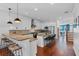 Modern kitchen featuring granite countertops, stainless steel appliances, an island with seating, and hardwood floors at 2109 E Central Blvd, Orlando, FL 32803