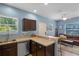 Stylish kitchenette with stainless steel sink, dark brown cabinets, countertops, and easy access to living room at 2109 E Central Blvd, Orlando, FL 32803