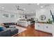 Open-concept living room with hardwood floors flows into kitchen, complete with modern ceiling fan and wet bar at 2109 E Central Blvd, Orlando, FL 32803