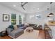 Open living room with hardwood floors, ceiling fan, and a gray sectional sofa at 2109 E Central Blvd, Orlando, FL 32803
