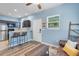 Apartment-style living room with small kitchen, bar seating, cozy furniture and a light blue paint at 2109 E Central Blvd, Orlando, FL 32803