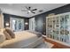 Stylish main bedroom featuring an ensuite bath, backyard access, hardwood flooring, and built-in shelves at 2109 E Central Blvd, Orlando, FL 32803