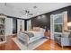 Stylish main bedroom with hardwood floors, dark accent wall, and cozy reading nook at 2109 E Central Blvd, Orlando, FL 32803