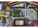 Covered outdoor kitchen with stainless steel grill, granite countertops, and a beautiful landscaped backyard at 2109 E Central Blvd, Orlando, FL 32803