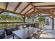Outdoor kitchen featuring a grill, refrigerator, dining table and backyard view at 2109 E Central Blvd, Orlando, FL 32803