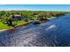 Aerial view of riverfront property with lush greenery, private dock, and boat at 2112 Shady Ln, Geneva, FL 32732