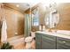 Elegant bathroom featuring an oval mirror, large vanity, and tile shower/tub combo at 2112 Shady Ln, Geneva, FL 32732